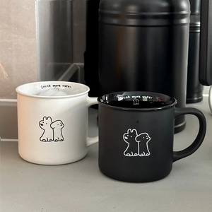 Detail of ceramic mugs with cute dog illustrations and drink more water inner rim text