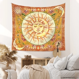 Detail of bohemian sun and moon tapestry with zodiac signs hung in a cozy bedroom