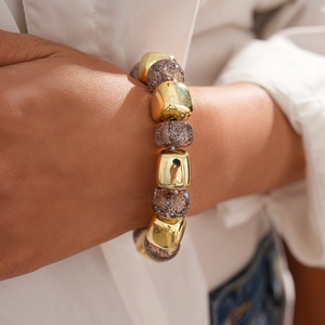 Detail of vintage geometric beaded bracelet with gold metal and sparkly resin beads