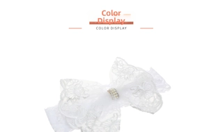 Detail of white lace baby headband with rhinestone and pearl bow buckle on white background