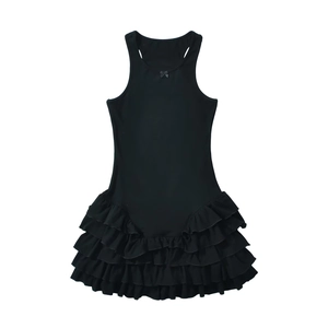 Detail of black sleeveless dress featuring multi-layer ruffled hem and neck bow decoration