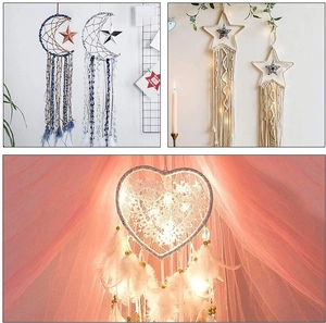 Detailed view of handmade moon and star dreamcatchers with warm LED lights for wall decor
