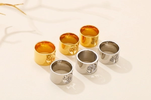 Polished titanium steel rings with tree of life cut-outs in gold and silver finishes