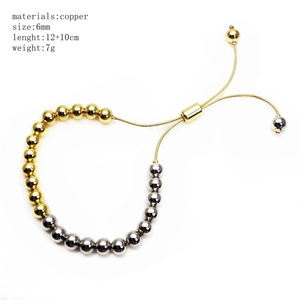 Detail showing 6mm gold and silver beaded copper bracelet with adjustable slider chain