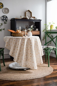 Detailed texture of white Christmas tablecloth with gold snowflakes and reindeer patterns