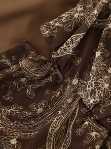 Macro detail of the invisible zipper and paisley pattern on the chiffon skirt