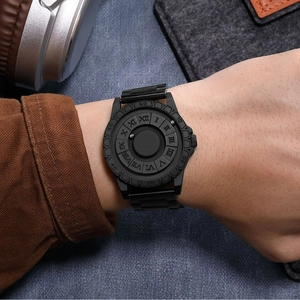 Matte black magnetic ball watch with steel link band worn on wrist for industrial look