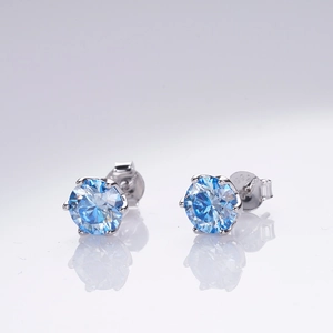 Close-up of S925 sterling silver earrings with 1 carat blue moissanite in six-prong setting