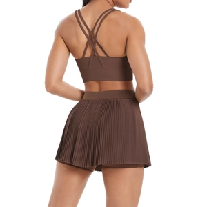 Two-piece sports set with brown cross-back tank top and pleated tennis skirt for fitness