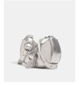 Detail of silver crescent moon bag featuring metallic PU leather and a large ring buckle