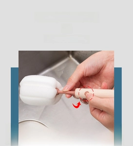 Close-up of the detachable white sponge head and pink handle with push-button lock