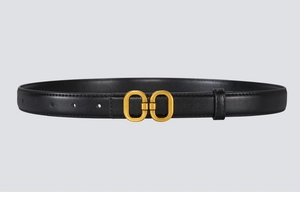 Close-up of black leather slim belt with matte gold double oval buckle and fine stitching
