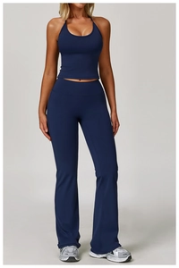 Detail showing the stretch navy blue fabric and flared hem of the yoga leggings set