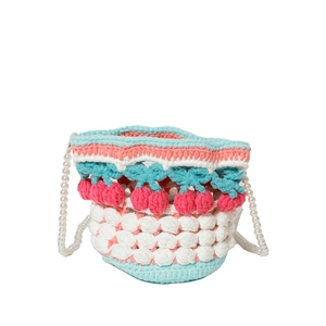 Detail of hand-knit bucket bag with 3D cherry accents and white faux pearl strap