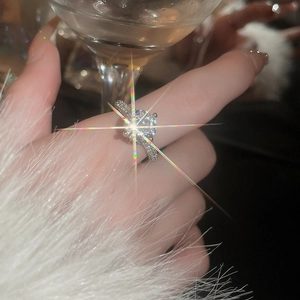 Detailed close-up of a silver ring with large cubic zirconia and paved accents