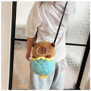 Detail of plush animal crossbody bag with adjustable strap on model for children