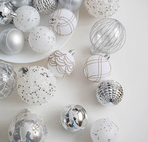 Macro shot of assorted champagne Christmas ornaments with glitter and matte textures