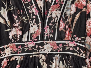 Detail of floral printed dress featuring a V-neckline and high waist seam design