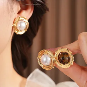 Vintage gold hoop earrings featuring elegant white pearls and brown tiger eye stones