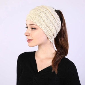 Close-up of cream knit headband for women with ponytail hole for winter warmth