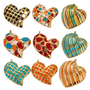 Nine heart-shaped gold-plated enamel pendants with various retro patterns on white background