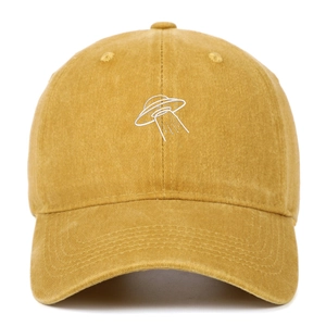 Close-up of UFO embroidery on mustard yellow washed cotton vintage baseball cap