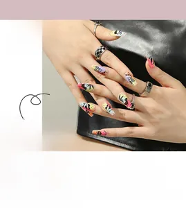 Detail of neon graffiti nails with skull and heart patterns on trapezoidal long tips