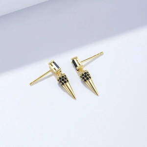 Detail of s925 silver cone earrings with pavé set black zircons and golden finish