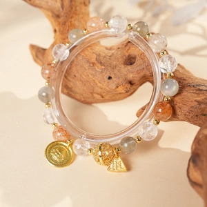 Detail of beaded bracelet with colorful crystals and gold Fu character pendants