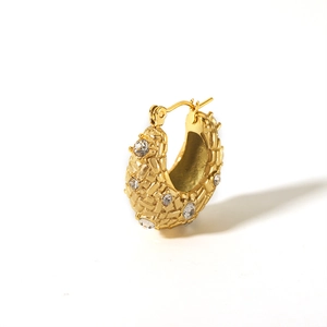Detail of 18K gold plated braided hoop earring with sparkling inlaid crystals