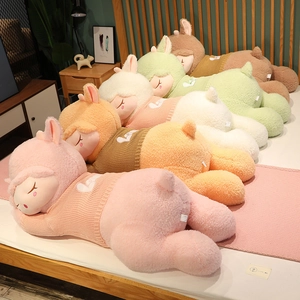 Detail of colorful alpaca plush pillows in teddy fleece with embroidered sweaters