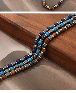 Close-up of beaded bracelets with tiger eye, lapis lazuli and turquoise on wood