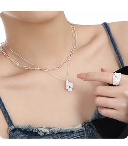 Irregular lava texture necklace and ring set with orange gemstone inlay on model