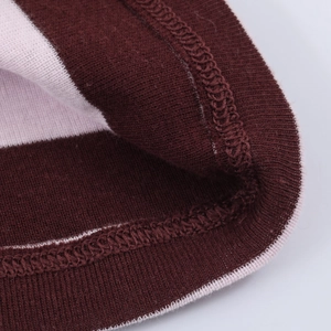 Close-up of wine red and pink striped knit sweater cuff with ribbed texture detail