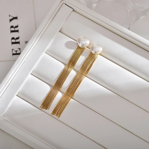 Elegant gold-plated tassel earrings with heart-shaped pearls in a white jewelry box