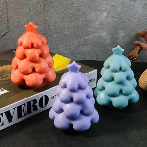 Three-piece set of matte Christmas tree candles in red, purple, and blue colors
