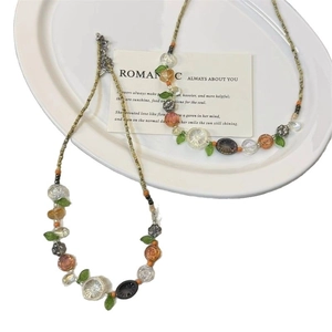 Colorful floral beaded necklace for summer with vibrant resin flowers and green leaf charms