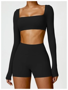 Close-up of black square-neck long sleeve cropped top and high-waist yoga shorts set
