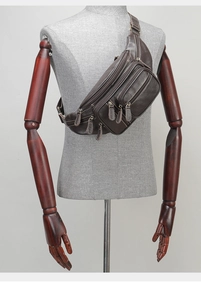 Detail view of dark coffee leather sling bag with lychee texture on a male mannequin