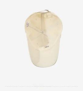 Interior view of beige baseball cap showing 100% cotton sweatband and inner stitching
