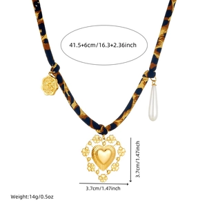 Leopard print fabric necklace with golden hollow heart pendant and embossed coin charm