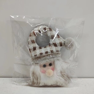 Detail of Santa plush ornament with brown plaid knit hat and white faux fur beard