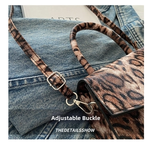 Macro detail of the adjustable silver metal buckle and leopard print strap of the handbag