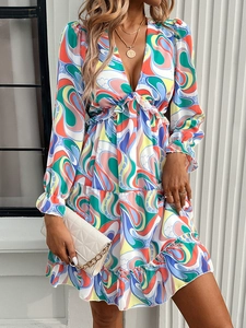 Detail of elegant V-neck dress featuring colorful abstract print and ruffle hem sleeves