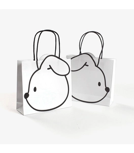 Detail of white paper gift bags featuring black cartoon rabbit ears with die-cut design