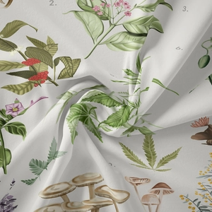 Detailed view of bohemian floral and mushroom prints on a white vintage botanical tapestry
