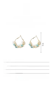 Detailed view of handmade baroque freshwater pearl hoop earrings with turquoise accents
