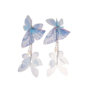 Blue mesh butterfly earrings with long fringe tassels and pearls on white background