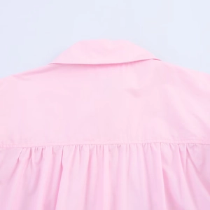 Detail of pink cotton poplin shirt showing the pleated neckline and collar texture