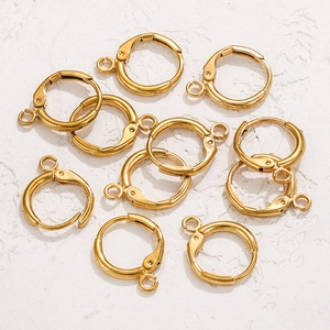 Close-up of 18K gold plated stainless steel leverback ear wires on textured stone